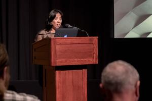 Grace Lee speaking behind the podium.