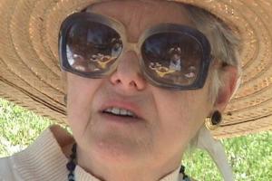 Shirley Price Katz wears sunglass and looks at the camera.