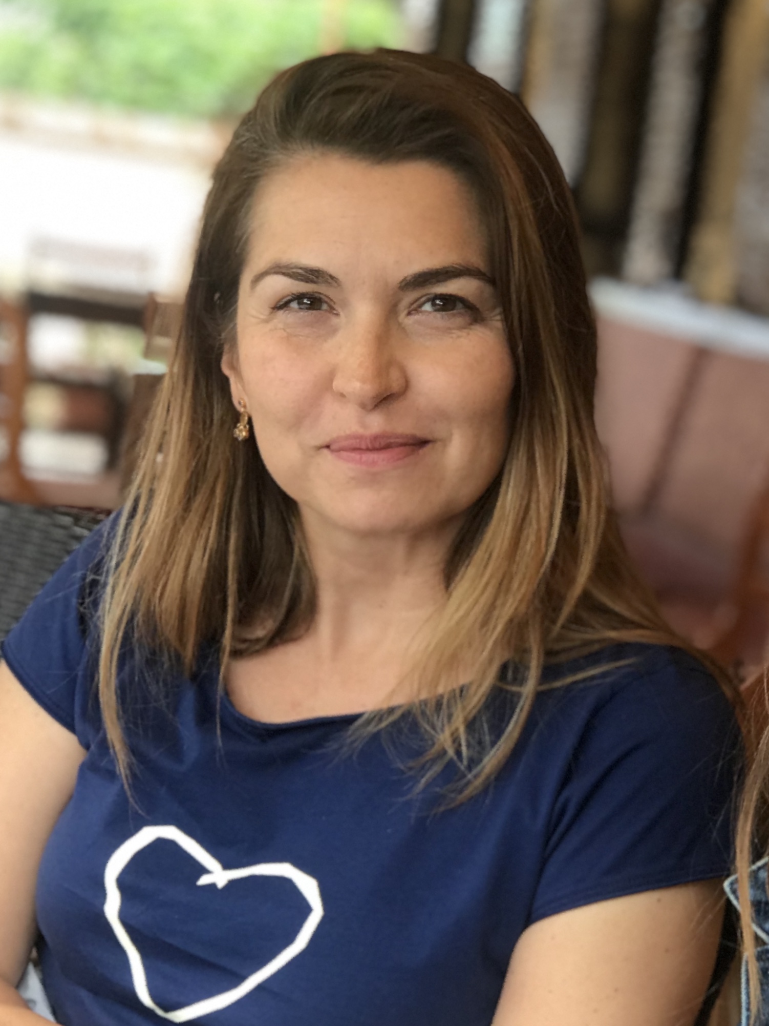 Headshot of Biljana Tutorov wearing a blue short sleeve shirt
