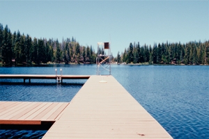 Lake Sequoia framed by trees, with boat docks and lifeguard chair in the foreground.