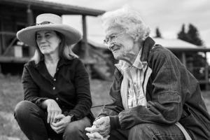 Black and white image of two women sitting down outdoors