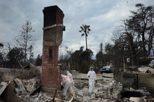 Jimmy Goldblum wearing a hazmat suit in the rubble of his Altadena home after the Easton Fires. 