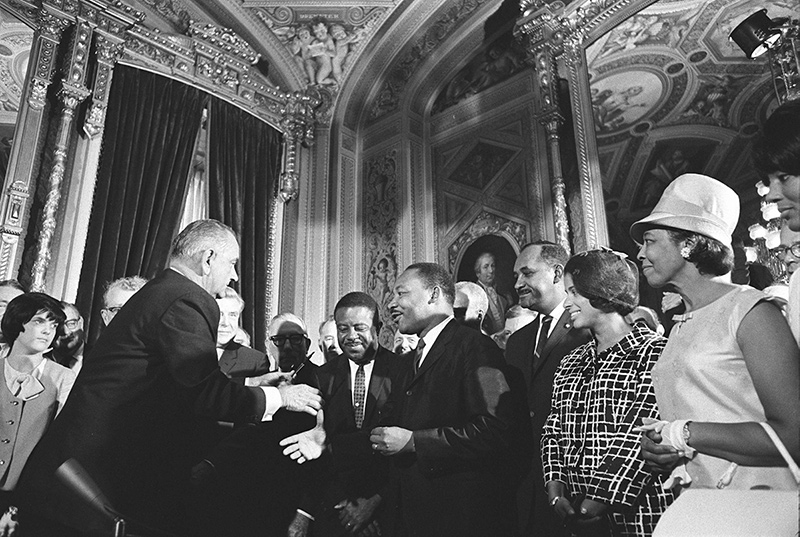 President Lyndon B. Johnson meets with Martin Luther King, Jr. at the signing of the Voting Rights Act of 1965. Photo by  Yoichi Okamoto. Public Domain.
