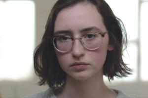 A photo of a female Caucasian with glasses.