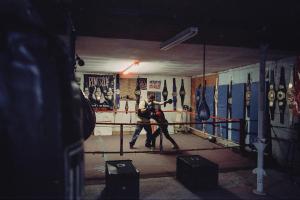 Mariah boxes with her male coach in an empty boxing gym