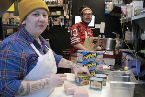 Two Filipino-American are preparing dishes in the kitchen.
