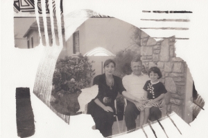 Collage-like black and white image of a man and a woman, with their young daughter in the father's lap