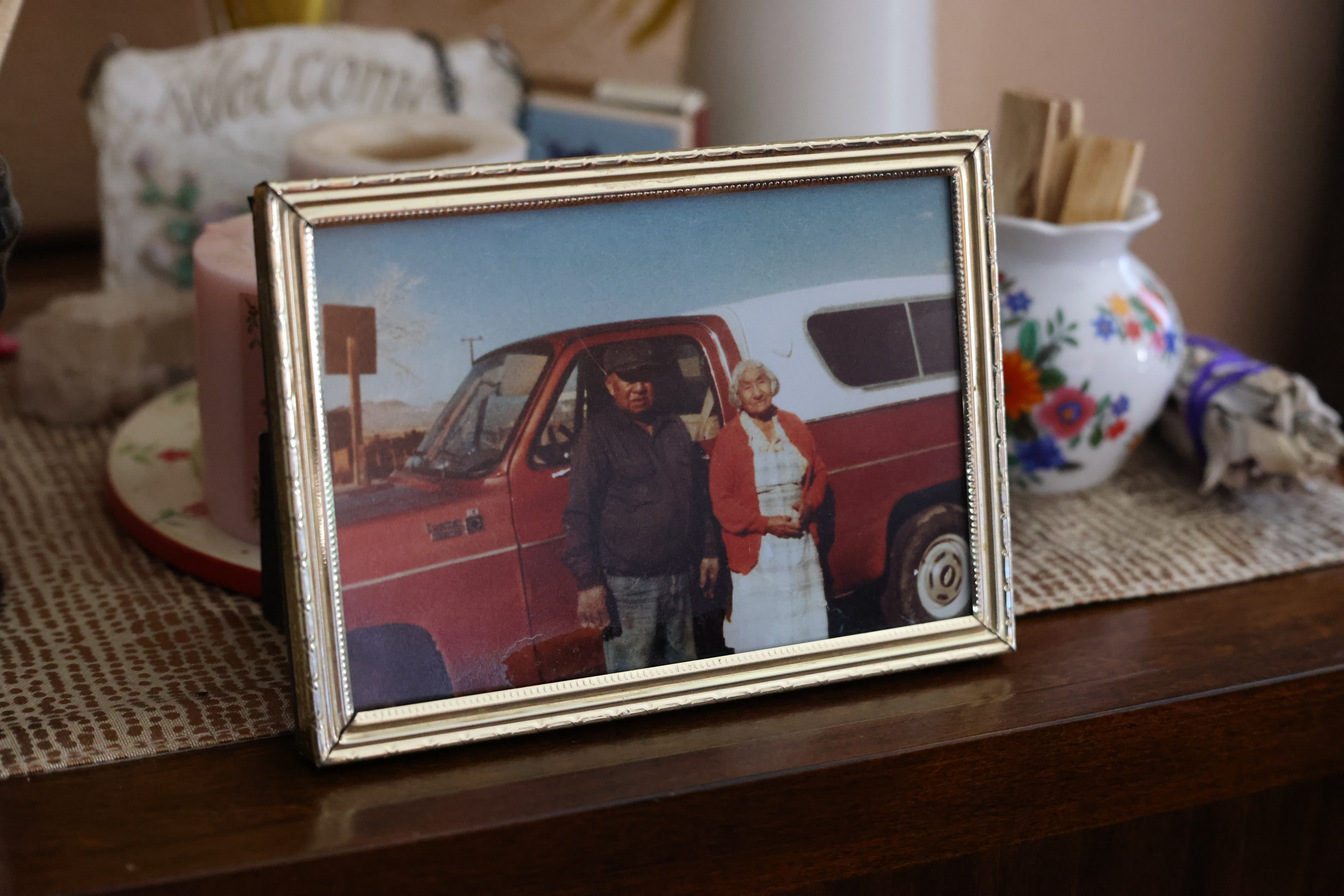 Film still from 'Remaining Native.' A picture frame on a dresser featuring a man and woman next to a red and white truck.