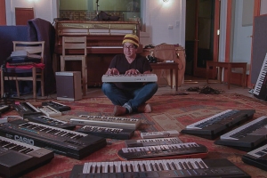 Musician Money Mark formerly of the Beasty Boys sits surrounded by various casios he uses to make his music.