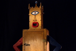 Still image from 'Westermann: Memorial to the Idea of Man If He Was an Idea,' depicting one of Westermann's wood sculptures against a black background.