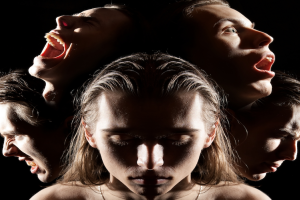 Image of a child with multiple faces behind.