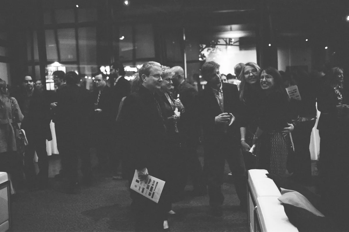 Faded black and white photo of well-dressed documentarians in the lobby of the DGA.