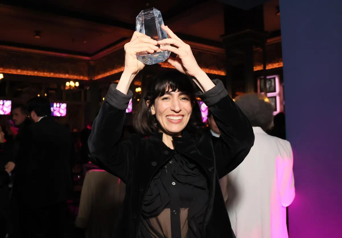 Tamar Baruch holding her trophy for David L Wolper Student Award at the 2024 IDA Documentary Awards. 