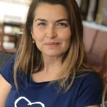 Headshot of Biljana Tutorov wearing a blue short sleeve shirt