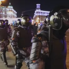 Heavily armed troops, wearing body armor, face shields and helmets, march through the streets of Moscow at night. From Gesbeen Mohammed’s ‘Putin’s War at Home,’ a ‘Frontline’ production currently streaming on PBS.org. Courtesy of ‘Frontline’.