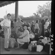 Archival photo of a Japanese family as they await a train that will take them to an internment camp. From Ken Burns’ ‘The U.S. and the Holocaust.’ Photo by Dorothea Lange. Image courtesy of PBS. 