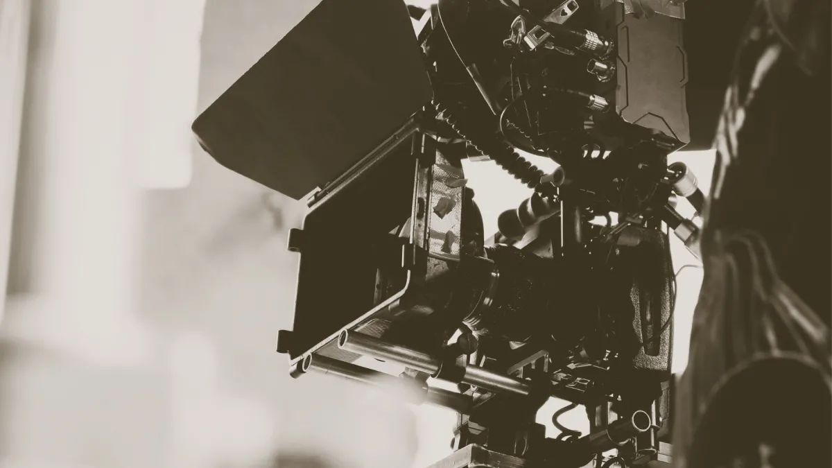 A black and white close up photo of a professional camera.